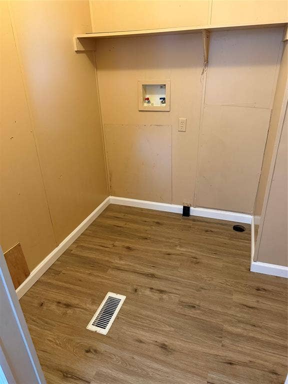 143 Summit Ridge Lane, Springtown, TX 76082 Utility space featuring wood-finish flooring, a wall-mounted shelf, and a washing machine hookup