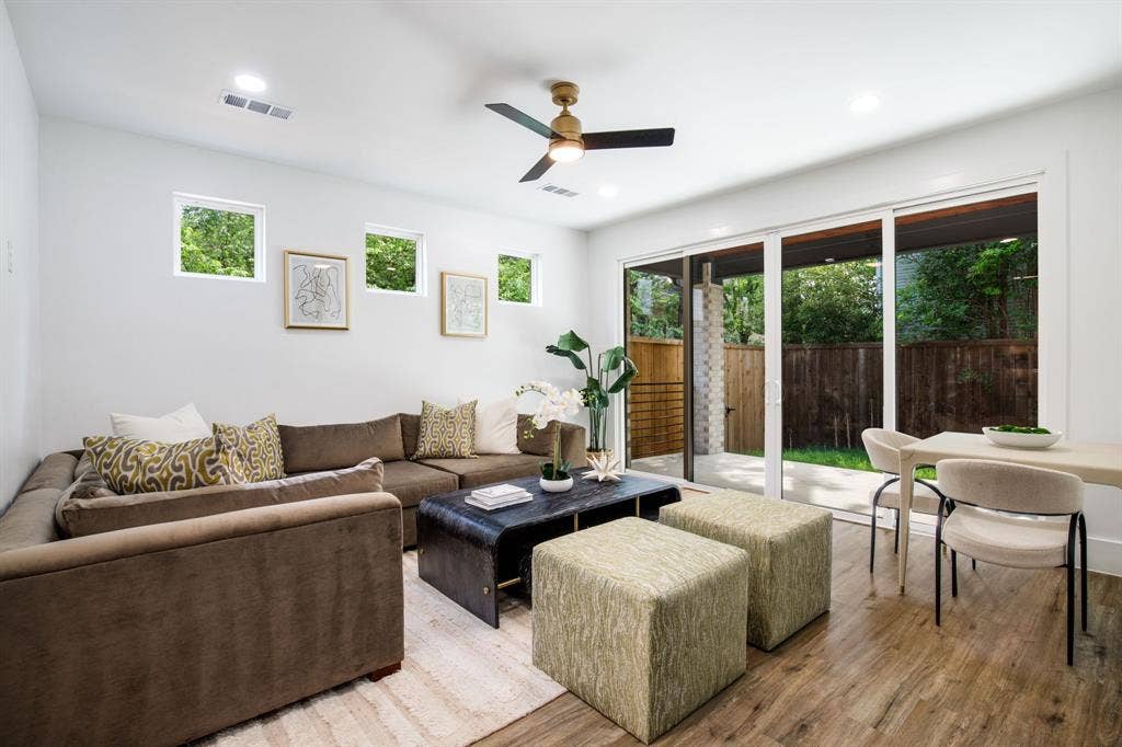 Recessed lighting, wood-finish flooring, ceiling fan, multiple windows, and a sliding glass door