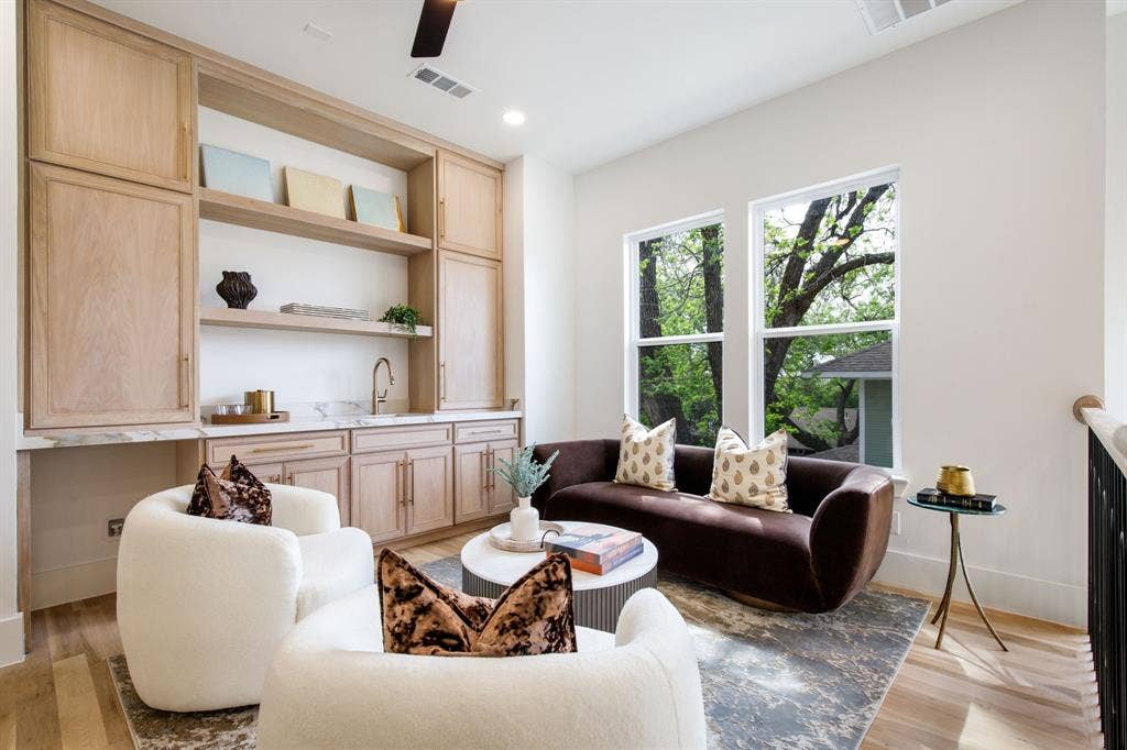 Built-in cabinetry with wood-finish doors, open shelving, and integrated sink