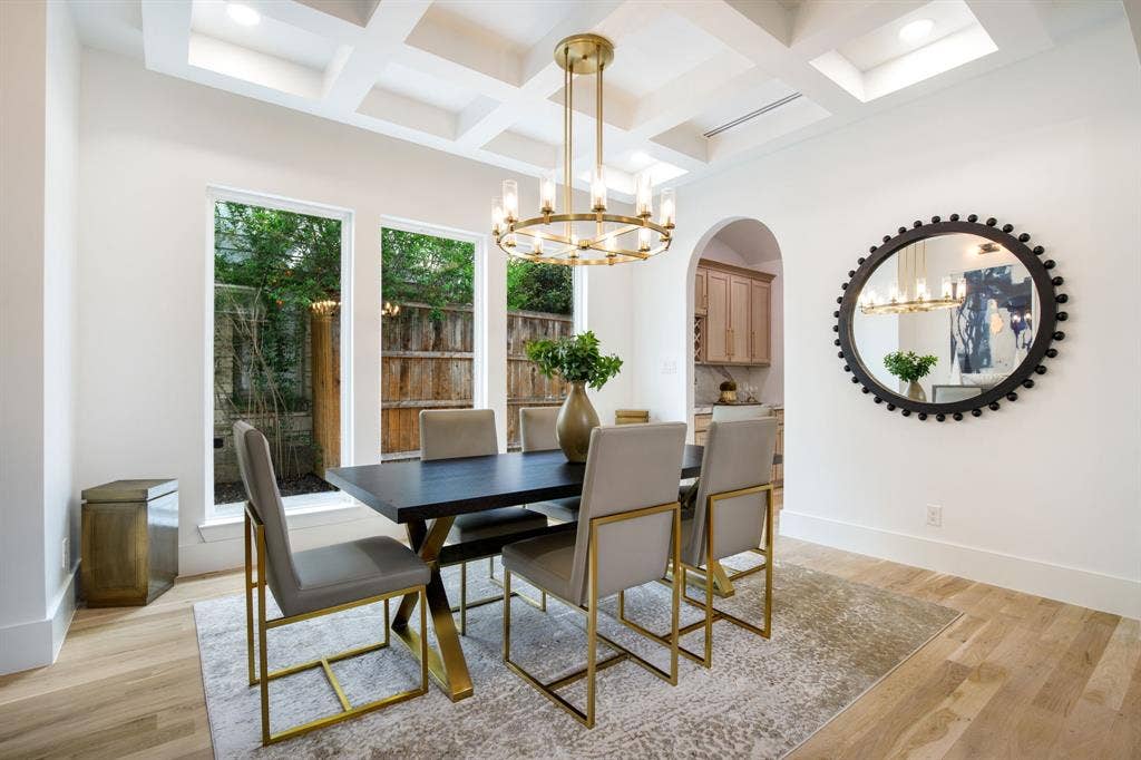Coffered ceiling, wood-finish flooring, and an arched doorway