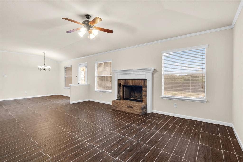 10108 Parker Springs Drive, Waco, TX 76708 Expansive living area featuring large format tile flooring, a brick fireplace with a white mantel, and multiple windows