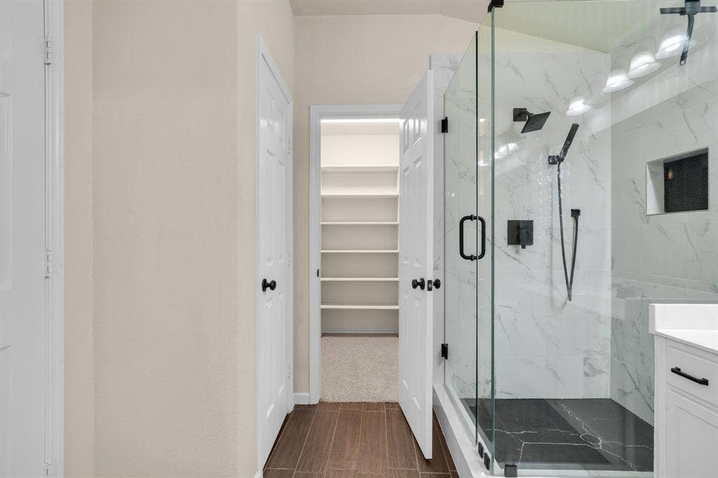 10108 Parker Springs Drive, Waco, TX 76708 Walk-in shower with clear glass enclosure and matte black fixtures