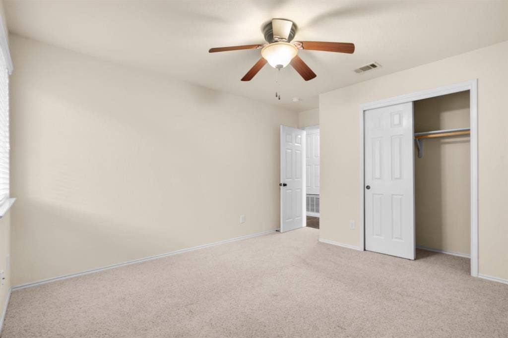 10108 Parker Springs Drive, Waco, TX 76708 Recessed window, ceiling fan with integrated lighting, neutral wall tones, sliding closet doors, and light-toned carpeting