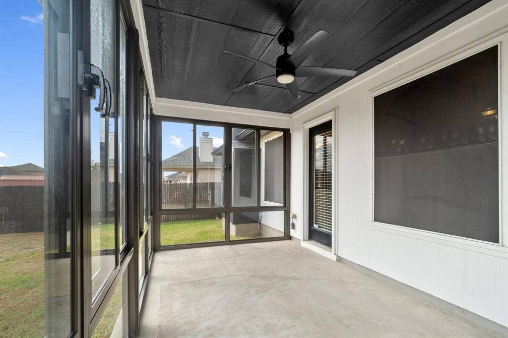 10108 Parker Springs Drive, Waco, TX 76708 Screened-in porch featuring a concrete floor, black ceiling fan, and white exterior wall with dark trim
