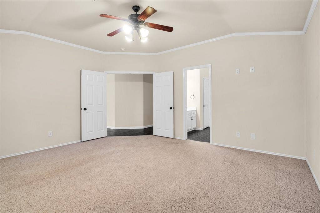 10108 Parker Springs Drive, Waco, TX 76708 Carpeted room with a ceiling fan, crown molding, and two panel doors