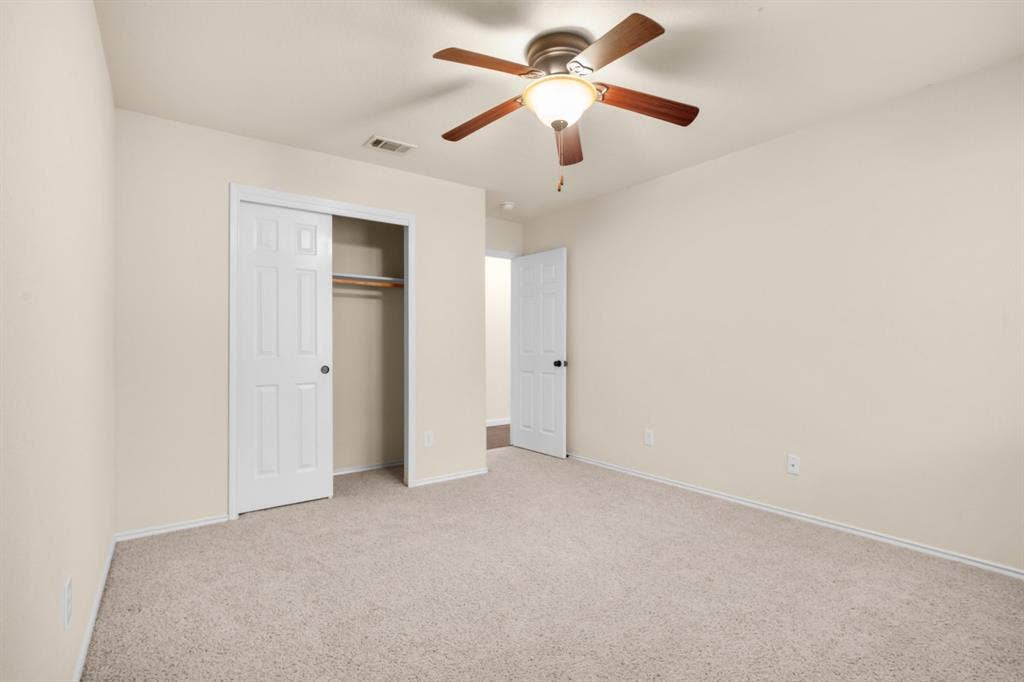 10108 Parker Springs Drive, Waco, TX 76708 Wall-to-wall carpeting, overhead ceiling fan with lighting, and white paneled doors