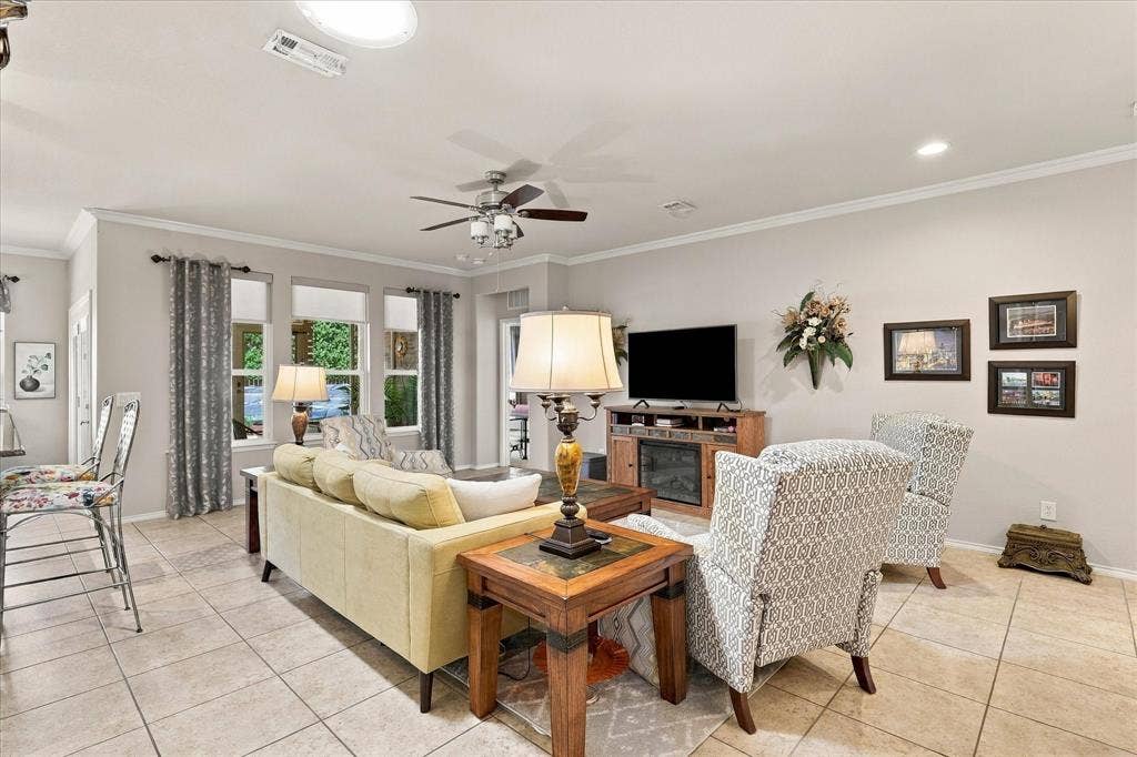 1118 Imperial Valley Lane, Frisco, TX 75036 Tiled flooring throughout living areas, crown molding and multiple windows