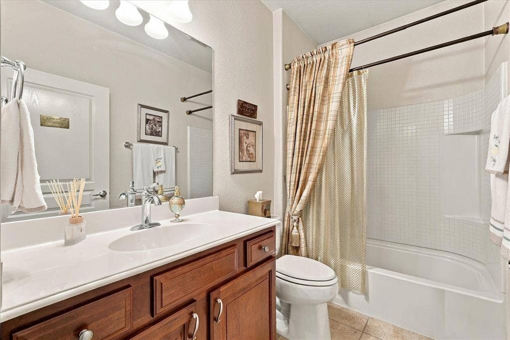 1118 Imperial Valley Lane, Frisco, TX 75036 Single vanity with a white countertop, chrome faucet, and wood-finish cabinetry