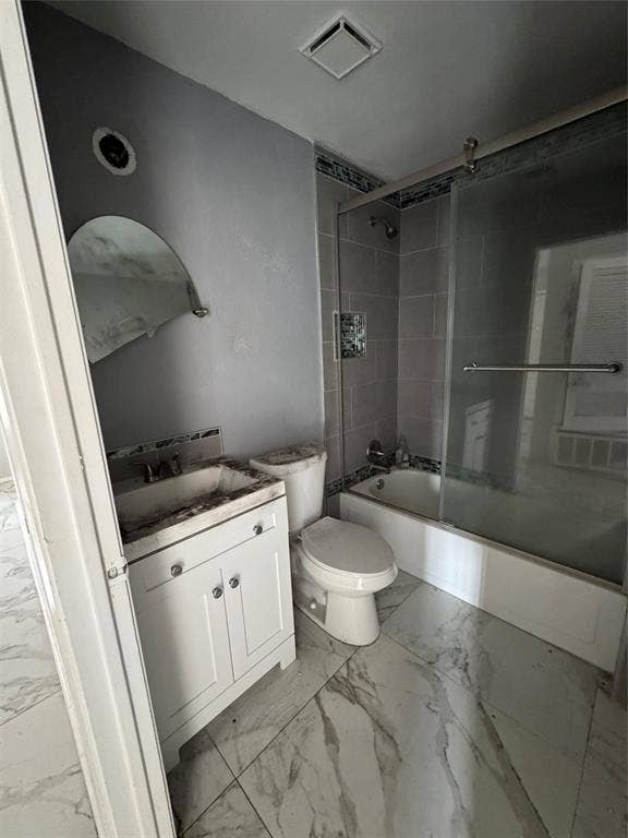415 E 20th Street, Waco, TX 76705 White vanity with base cabinetry, wall-mounted mirror, white toilet, and a tiled shower with a sliding glass enclosure