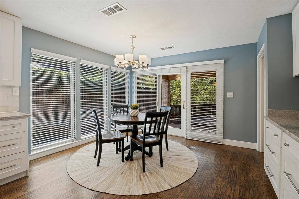 17411 Oakington Court, Dallas, TX 75252 Breakfast room, surrounded by windows, provides more storage and a serving counter. Access to the covered patio, deck, yard, and creek.