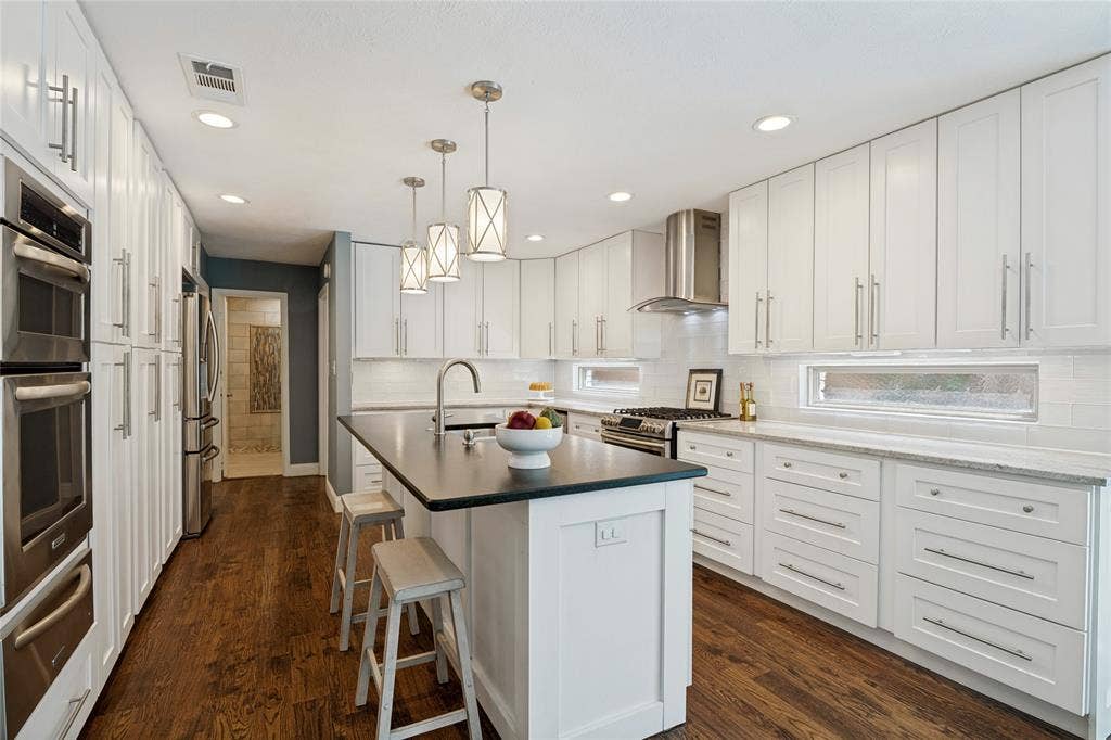 17411 Oakington Court, Dallas, TX 75252 Fabulous custom designed kitchen features island with breakfast bar, pendant lighting, and top appliances.