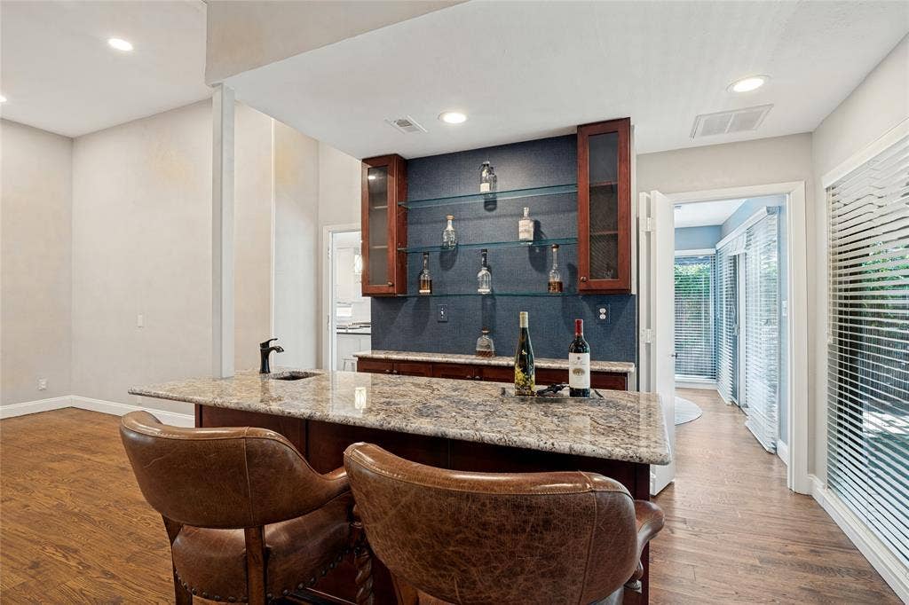 17411 Oakington Court, Dallas, TX 75252 Detail of wet bar with storage and seating.