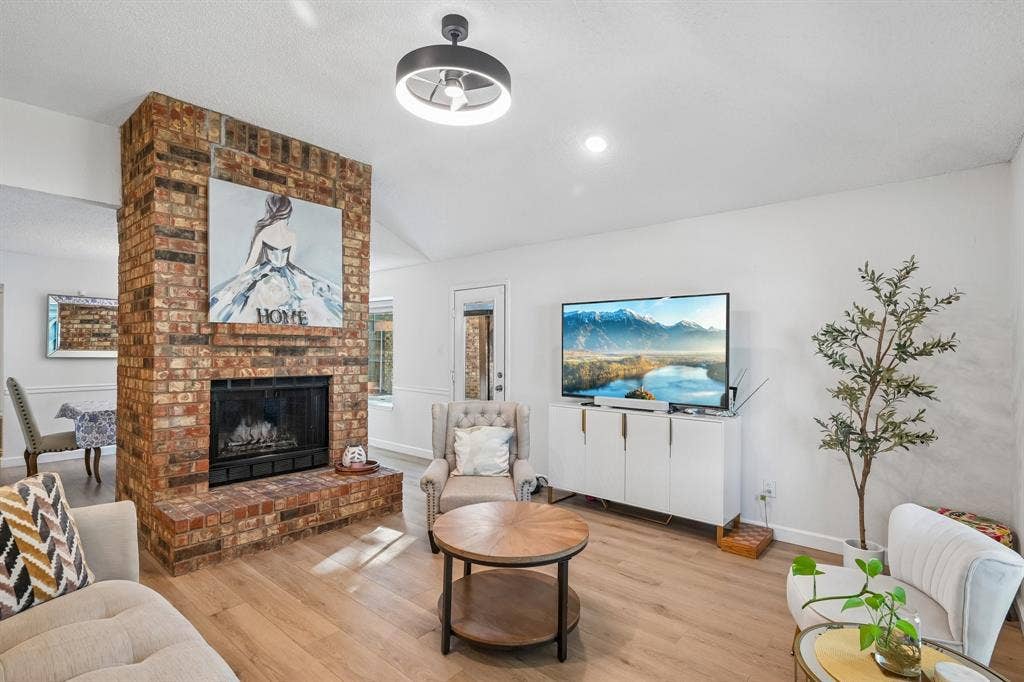 322 Valley Spring Drive, Arlington, TX 76018 Living room featuring wood burning fireplace