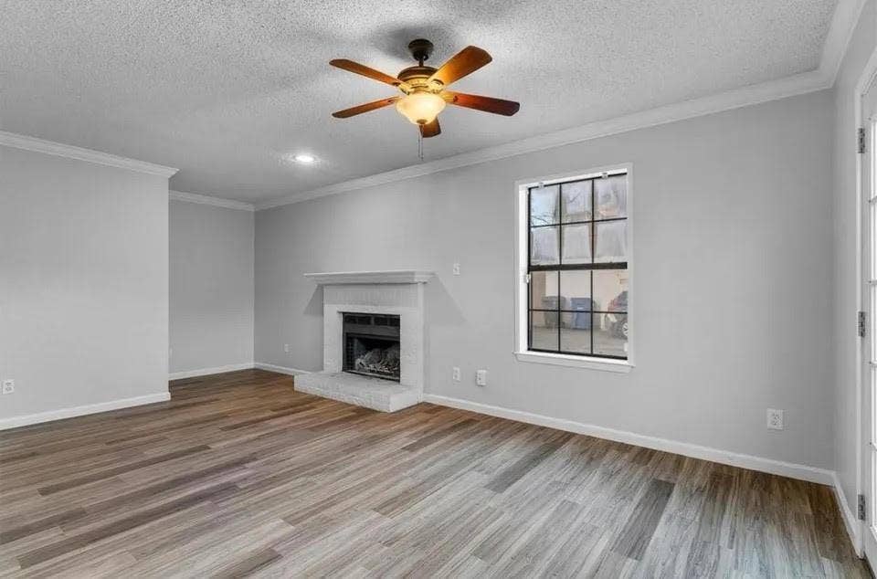 5326 Columbia Avenue, Dallas, TX 75214 A spacious living room featuring a ceiling fan and a fireplace, creating a cozy atmosphere.