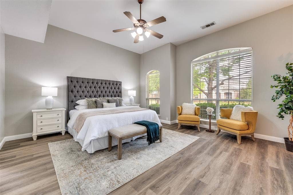 2873 Del Largo Way, Frisco, TX 75033 Vaulted ceiling with a ceiling fan, wood-finish flooring, two arched windows, and white window blinds