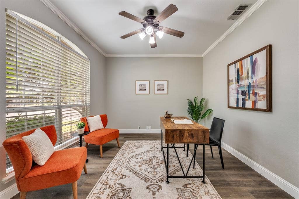 2873 Del Largo Way, Frisco, TX 75033 Bright home office featuring large plantation-style shutters flooding the space with natural light, wood-finish flooring, and neutral wall finishes