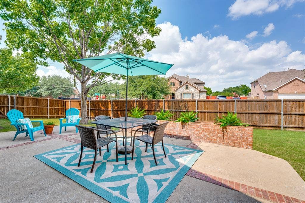 2873 Del Largo Way, Frisco, TX 75033 Expansive concrete patio with brick accents, wood privacy fencing, and a brick planter box