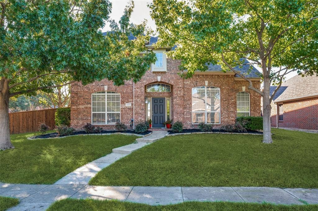 2873 Del Largo Way, Frisco, TX 75033 Brick exterior with arched entry, arched windows, and a paved walkway