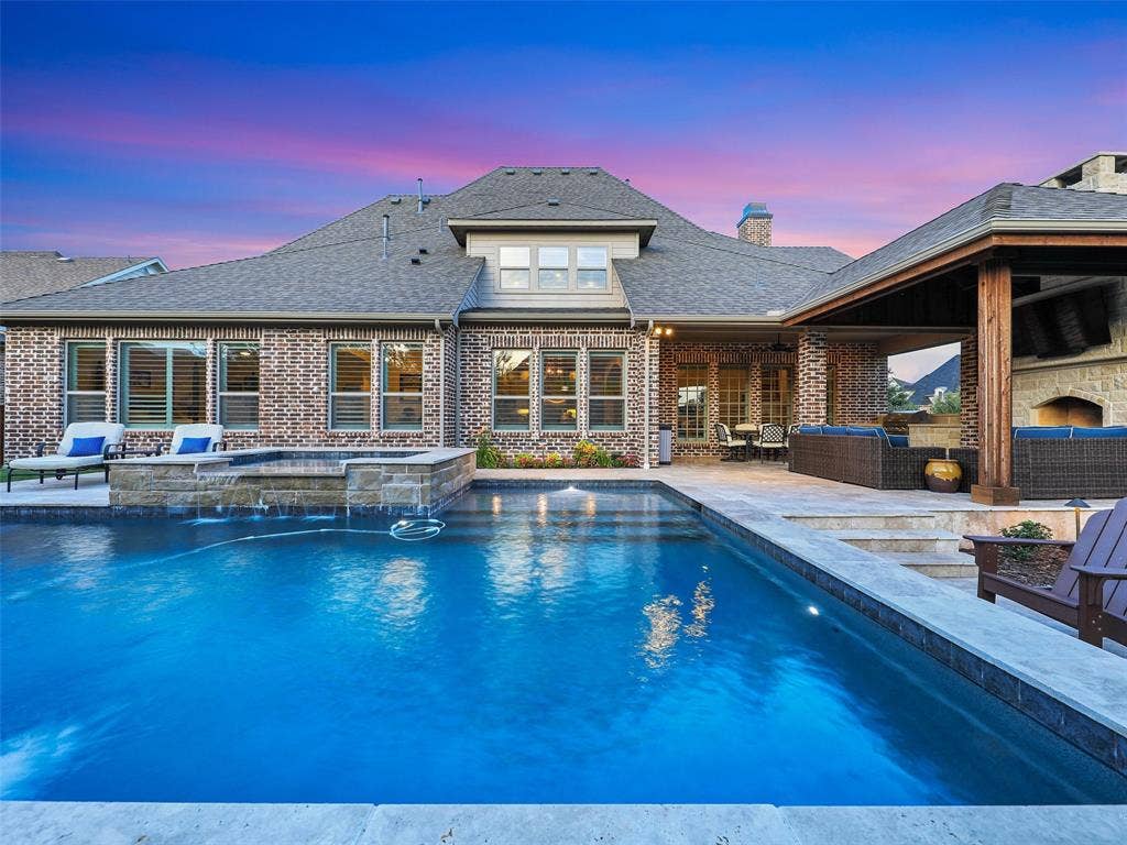 12921 Railhead Court, Frisco, TX 75033 Outside, the property transforms into a private resort designed for year-round enjoyment. The Foley Pools swimming pool, completed in 2021, is complemented by an oversized spa with seating for approximately 10. Travertine limestone surrounds the pool and is used throughout the decking and coping, giving the outdoor environment a cohesive, upscale finish. Pentair pool equipment with wireless controls provides convenient operation, while individual pumps for the pool features allow greater flexibility and independent control.