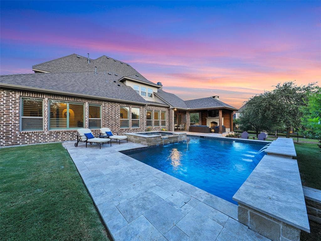 12921 Railhead Court, Frisco, TX 75033 Outside, the property transforms into a private resort designed for year-round enjoyment. The Foley Pools swimming pool, completed in 2021, is complemented by an oversized spa with seating for approximately 10. Travertine limestone surrounds the pool and is used throughout the decking and coping, giving the outdoor environment a cohesive, upscale finish. Pentair pool equipment with wireless controls provides convenient operation, while individual pumps for the pool features allow greater flexibility and independent control.
