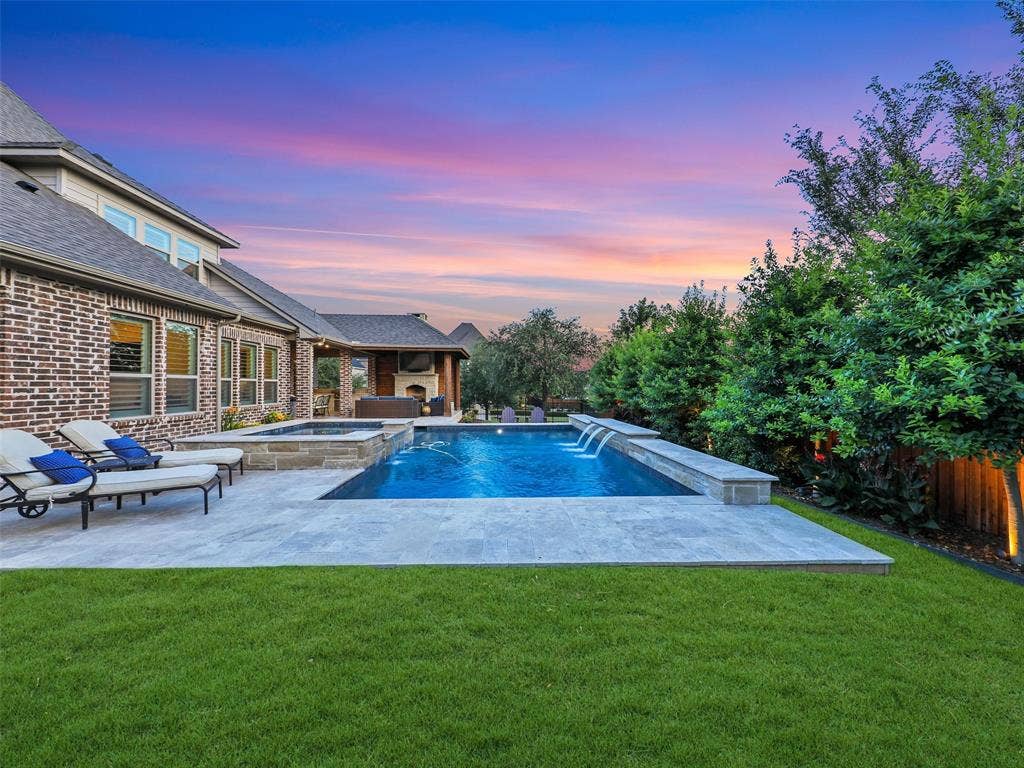 12921 Railhead Court, Frisco, TX 75033 Outside, the property transforms into a private resort designed for year-round enjoyment. The Foley Pools swimming pool, completed in 2021, is complemented by an oversized spa with seating for approximately 10. Travertine limestone surrounds the pool and is used throughout the decking and coping, giving the outdoor environment a cohesive, upscale finish. Pentair pool equipment with wireless controls provides convenient operation, while individual pumps for the pool features allow greater flexibility and independent control.