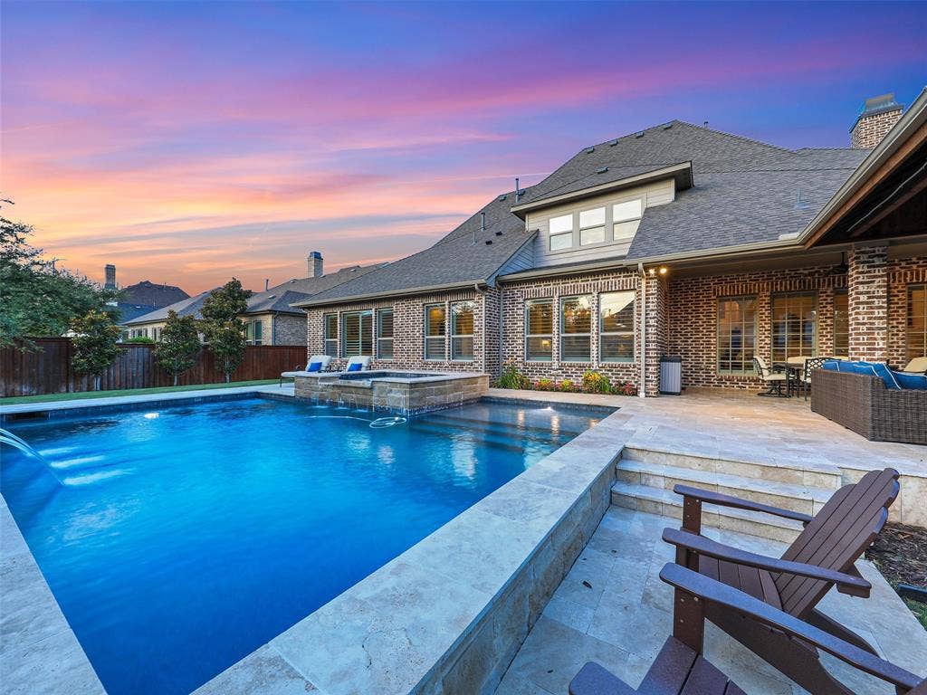 12921 Railhead Court, Frisco, TX 75033 Outside, the property transforms into a private resort designed for year-round enjoyment. The Foley Pools swimming pool, completed in 2021, is complemented by an oversized spa with seating for approximately 10. Travertine limestone surrounds the pool and is used throughout the decking and coping, giving the outdoor environment a cohesive, upscale finish. Pentair pool equipment with wireless controls provides convenient operation, while individual pumps for the pool features allow greater flexibility and independent control.