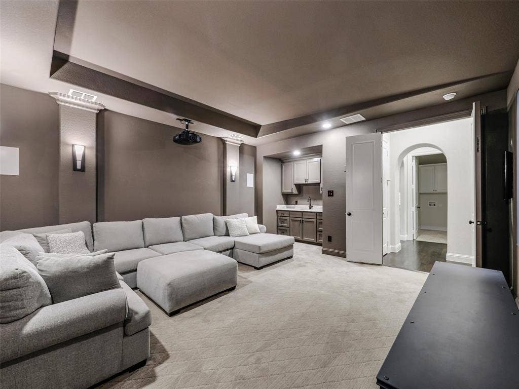 12921 Railhead Court, Frisco, TX 75033 DOWN-STAIRS-MEDIA. Majorly sought after floor plan. GUEST and MEDIA DOWN. Oversized GARAGE SPACES. The home's entertainment spaces continue with a dedicated media room featuring sconce lighting and a substantial 6-by-4-foot wet bar. Whether hosting movie nights, sporting events, or gatherings with friends, this flexible space provides another destination for entertaining without leaving home.