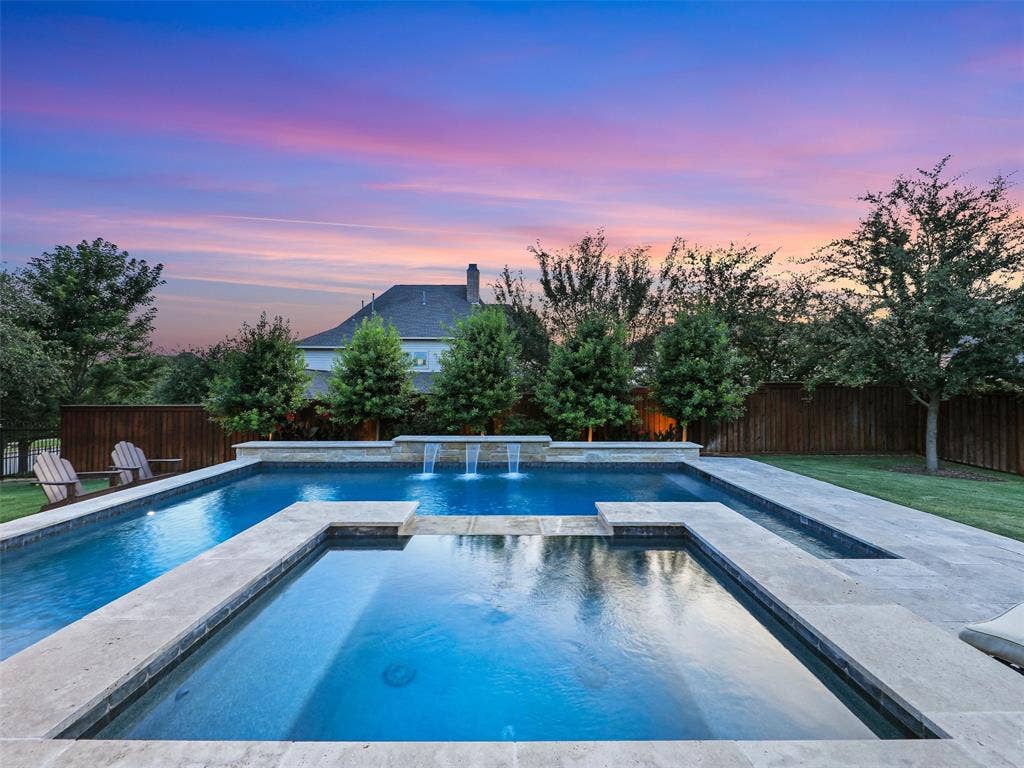 12921 Railhead Court, Frisco, TX 75033 Outside, the property transforms into a private resort designed for year-round enjoyment. The Foley Pools swimming pool, completed in 2021, is complemented by an oversized spa with seating for approximately 10. Travertine limestone surrounds the pool and is used throughout the decking and coping, giving the outdoor environment a cohesive, upscale finish. Pentair pool equipment with wireless controls provides convenient operation, while individual pumps for the pool features allow greater flexibility and independent control.