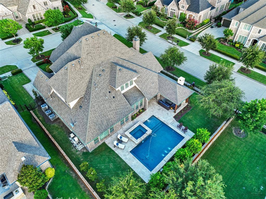 12921 Railhead Court, Frisco, TX 75033 HUGE OPEN YARD SPACES. GREAT for play, pets, and family entertaining. From the climate-controlled 800-bottle wine cellar and custom interior finishes to the Foley pool, oversized spa, limestone outdoor living center, extensive garage space, and numerous recent mechanical and exterior improvements, this Newman Village residence has been thoughtfully enhanced at nearly every turn. Designed for those who appreciate quality craftsmanship, generous entertaining spaces, and resort-inspired outdoor living, the home delivers an exceptional combination of elegance, functionality, and comfort in one of the area's distinctive residential communities.