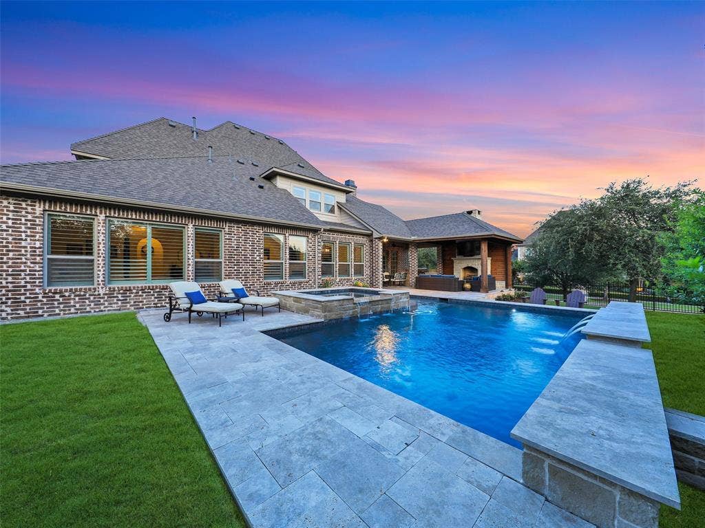 12921 Railhead Court, Frisco, TX 75033 Outside, the property transforms into a private resort designed for year-round enjoyment. The Foley Pools swimming pool, completed in 2021, is complemented by an oversized spa with seating for approximately 10. Travertine limestone surrounds the pool and is used throughout the decking and coping, giving the outdoor environment a cohesive, upscale finish. Pentair pool equipment with wireless controls provides convenient operation, while individual pumps for the pool features allow greater flexibility and independent control.