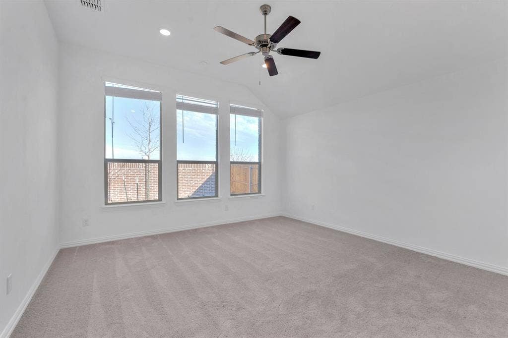 7204 Black Cherry Lane, McKinney, TX 75071 Carpeted spare room featuring ceiling fan, lofted ceiling, and recessed lighting