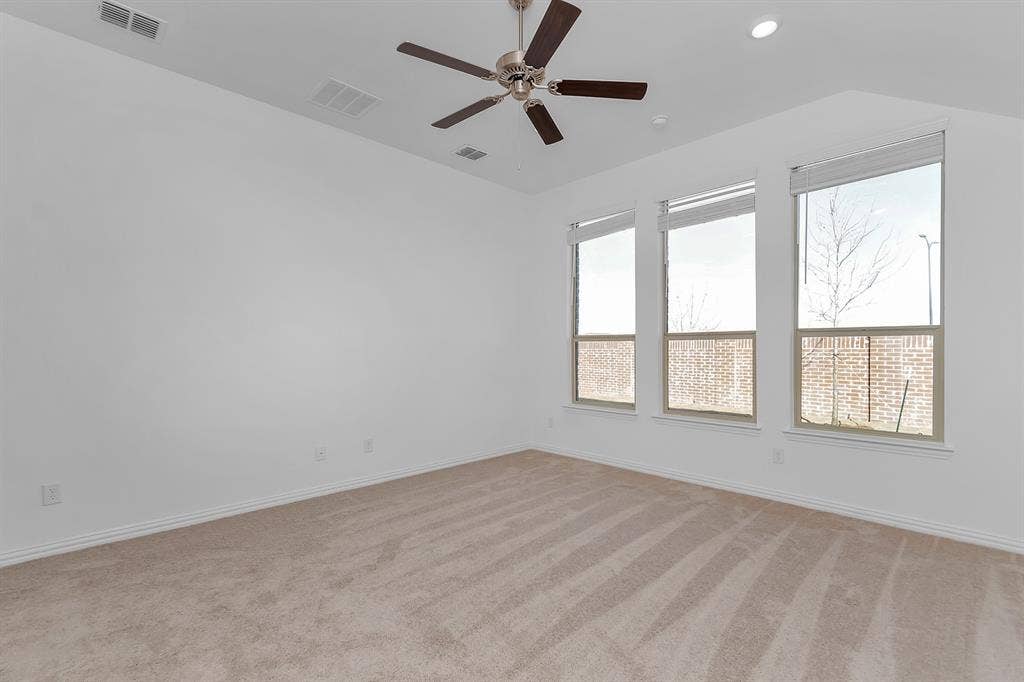 7204 Black Cherry Lane, McKinney, TX 75071 Empty room with ceiling fan, light carpet, vaulted ceiling, and recessed lighting