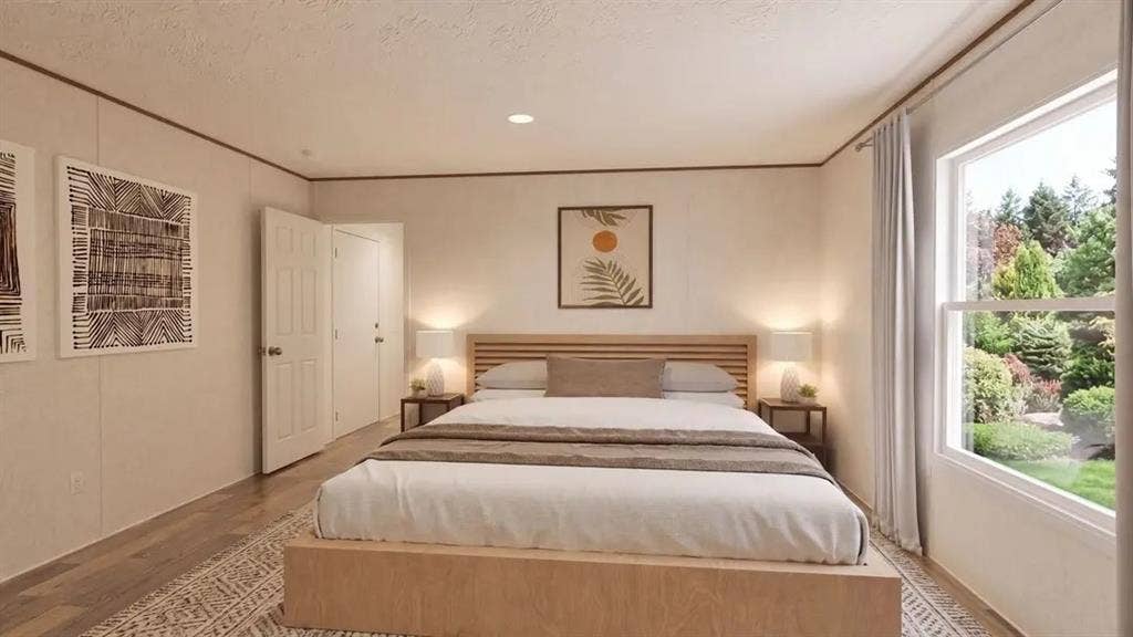 Bedroom featuring wood-finish flooring, recessed lighting, and a large window with exterior greenery