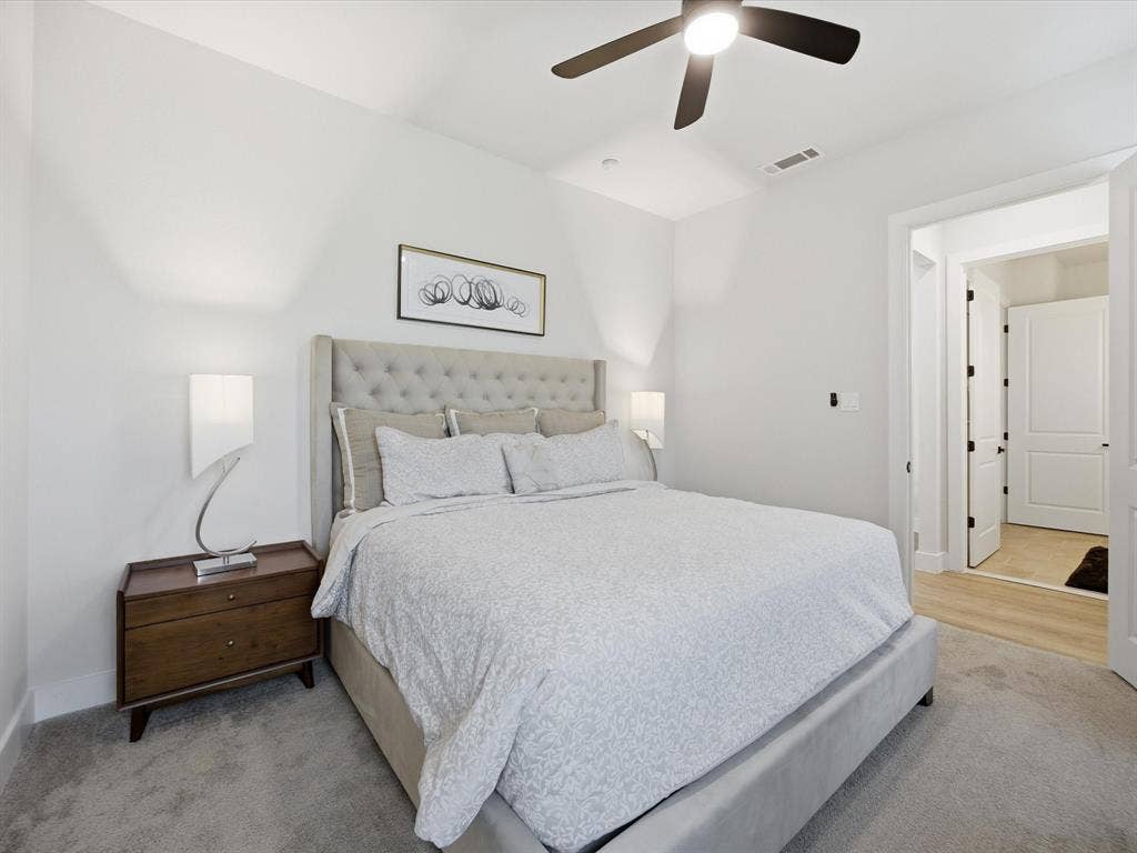 Bedroom with a ceiling fan and baseboards