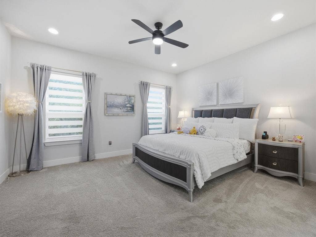 Bedroom featuring light carpet, a ceiling fan, and recessed lighting
