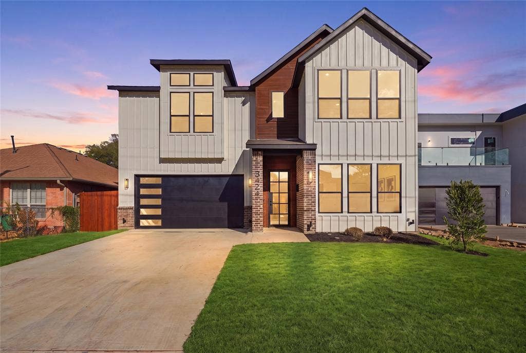 3424 Navaro Street, Dallas, TX 75212 Contemporary exterior featuring vertical siding, brick accents, a flat roofline, an integrated garage with frosted glass panels, and multiple large windows