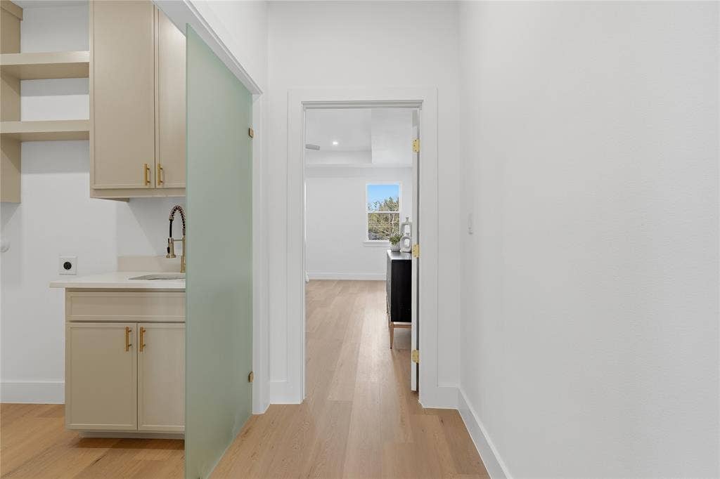 3424 Navaro Street, Dallas, TX 75212 Built-in cabinetry with gold-toned hardware, white countertop, and gold-toned faucet