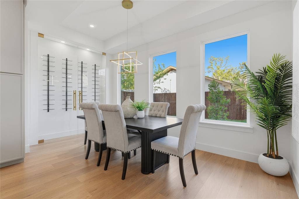 3424 Navaro Street, Dallas, TX 75212 Light wood-finish flooring, white walls, recessed ceiling lighting, and a geometric chandelier