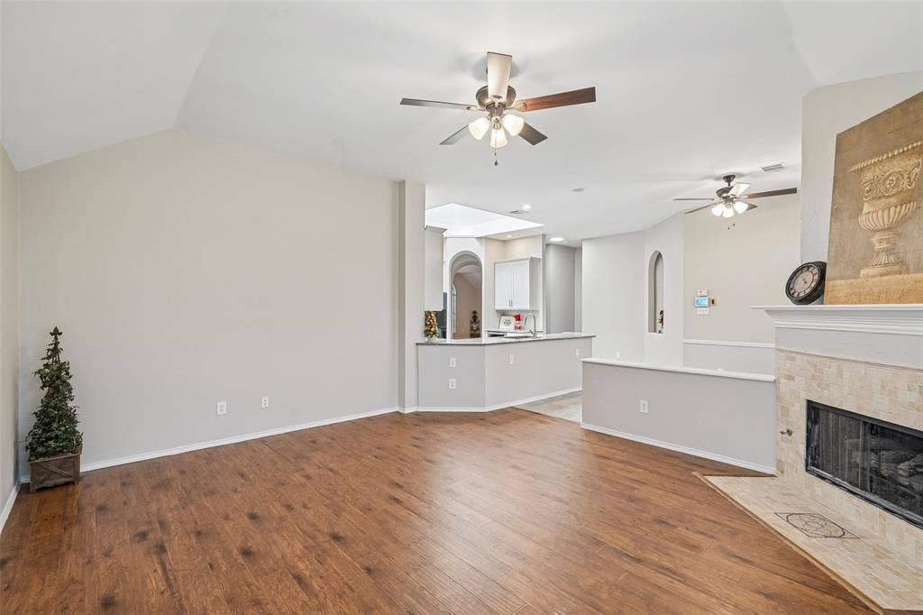 Wood-finish flooring, vaulted ceiling, and recessed lighting
