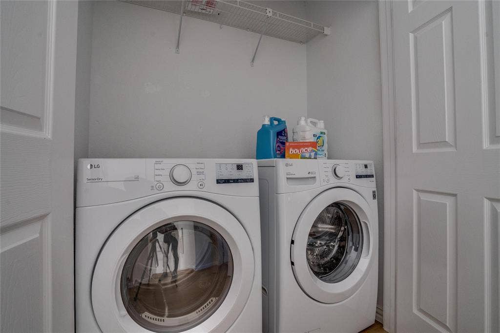6003 Lloyd Court, Dallas, TX 75252 Dedicated laundry area featuring a white wire shelving unit and panel doors