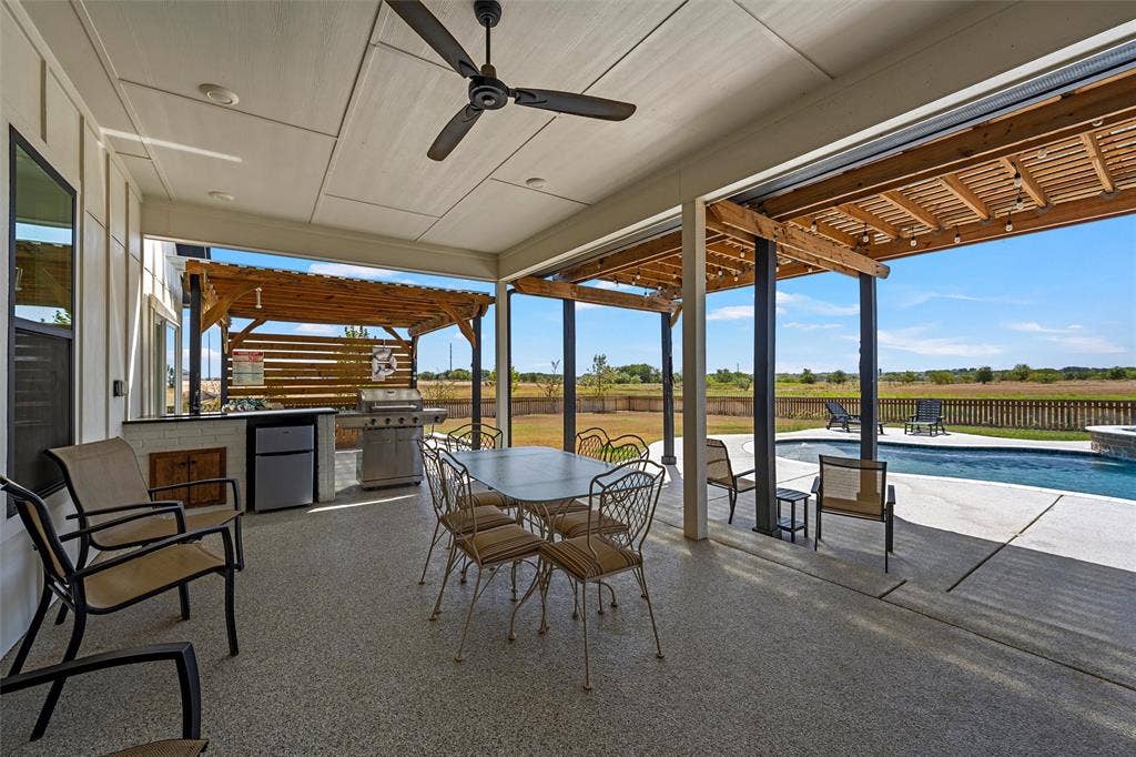 446 Wade Drive, Eddy, TX 76524 Covered patio featuring an outdoor kitchen with built-in grill, wood pergola, ceiling fan, recessed lighting, and a swimming pool