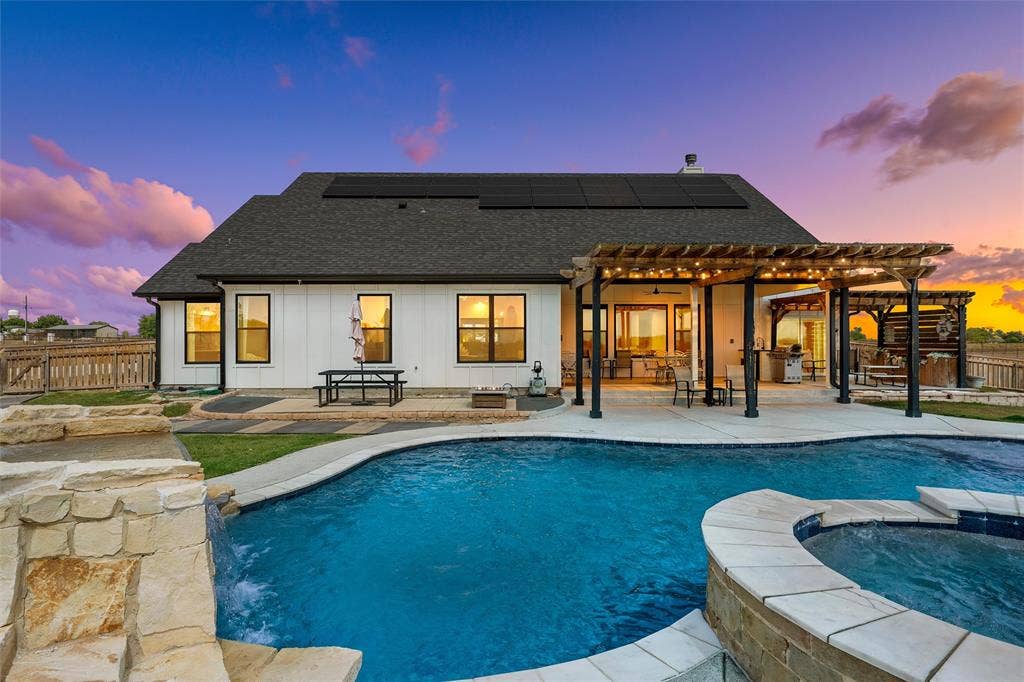 446 Wade Drive, Eddy, TX 76524 In-ground swimming pool with integrated spa and stone waterfall feature