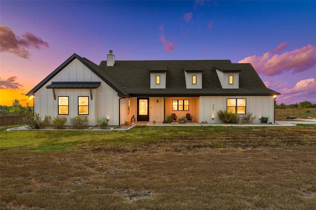 446 Wade Drive, Eddy, TX 76524 Board and batten exterior with dark trim accents, a prominent front door, and multiple dormer windows