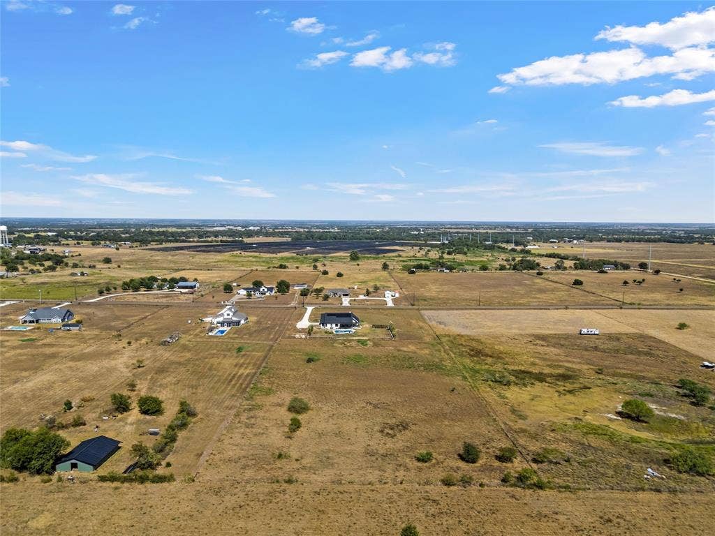 446 Wade Drive, Eddy, TX 76524 Rural landscape featuring expansive undeveloped land, scattered residential structures, and distant agricultural fields