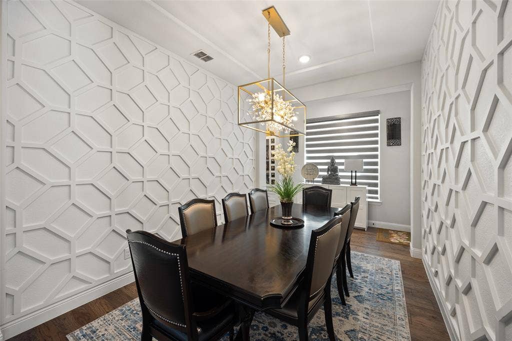 12512 Deer Trail, Frisco, TX 75035 Decorative accent wall panels, recessed ceiling detail, and a modern rectangular chandelier