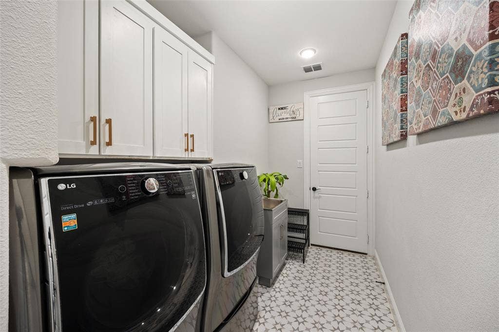 12512 Deer Trail, Frisco, TX 75035 White shaker-style cabinetry with gold-tone hardware, recessed ceiling lighting, five-panel interior door with black hardware, patterned floor tile, and a built-in utility sink