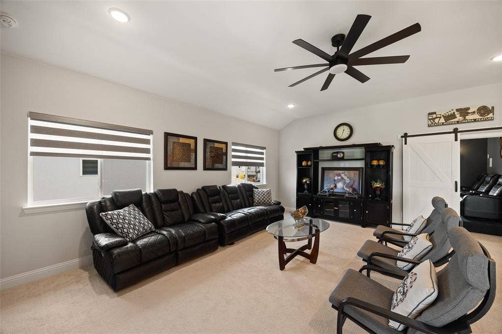 12512 Deer Trail, Frisco, TX 75035 Vaulted ceiling, recessed lighting, modern ceiling fan, built-in entertainment center, and a barn door