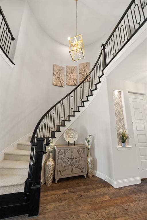 12512 Deer Trail, Frisco, TX 75035 Curved staircase with black metal balusters, carpeted treads, and a wood newel post