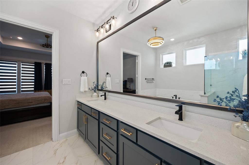 12512 Deer Trail, Frisco, TX 75035 Dual vanity with stone-look countertop, undermount sinks, and matte black fixtures