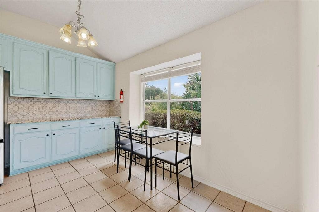 320 Elizabeth Trail, Murphy, TX 75094 Kitchen with tile flooring, light blue cabinetry, patterned tile backsplash, and a window with blinds